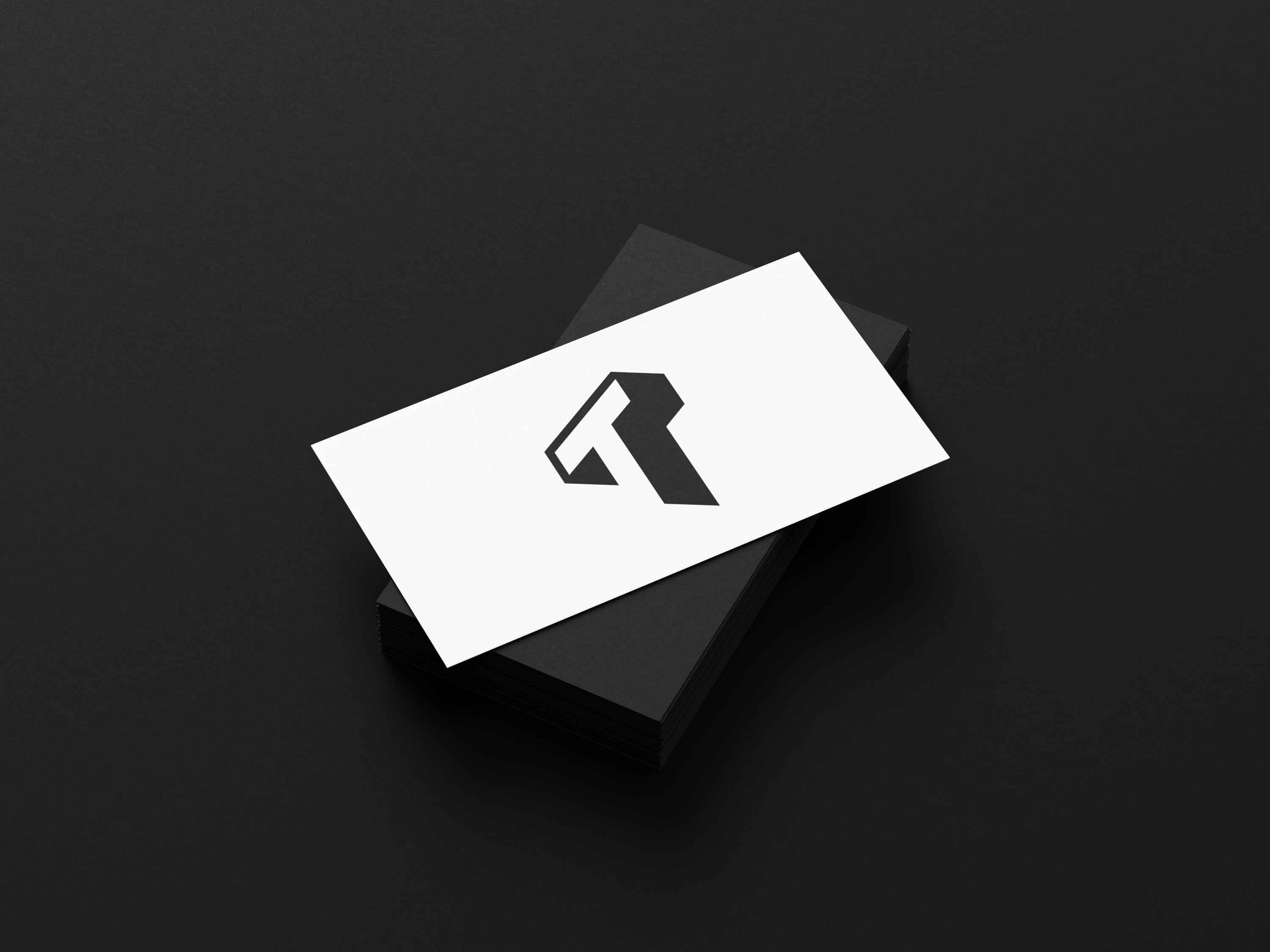 An 'T' logo design for myself, Tom Yan, in a white bookmark on top of the black box with a black background.